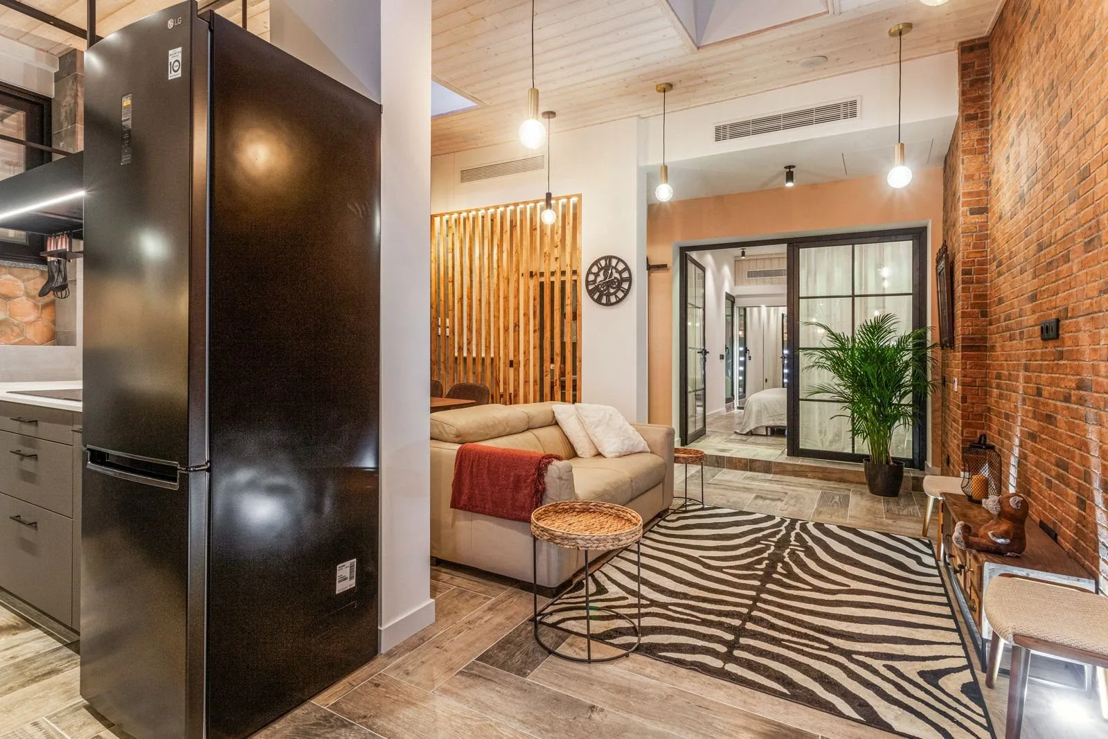 Kitchen opening onto living area — Amoreira loft conversion Cascais by Maya's Homes