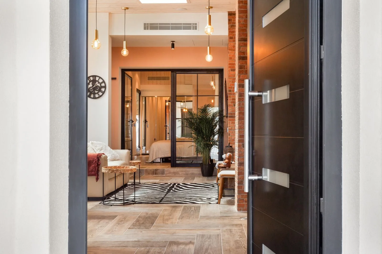 Living room entrance with steel-frame glass doors — Amoreira loft conversion Cascais by Maya's Homes