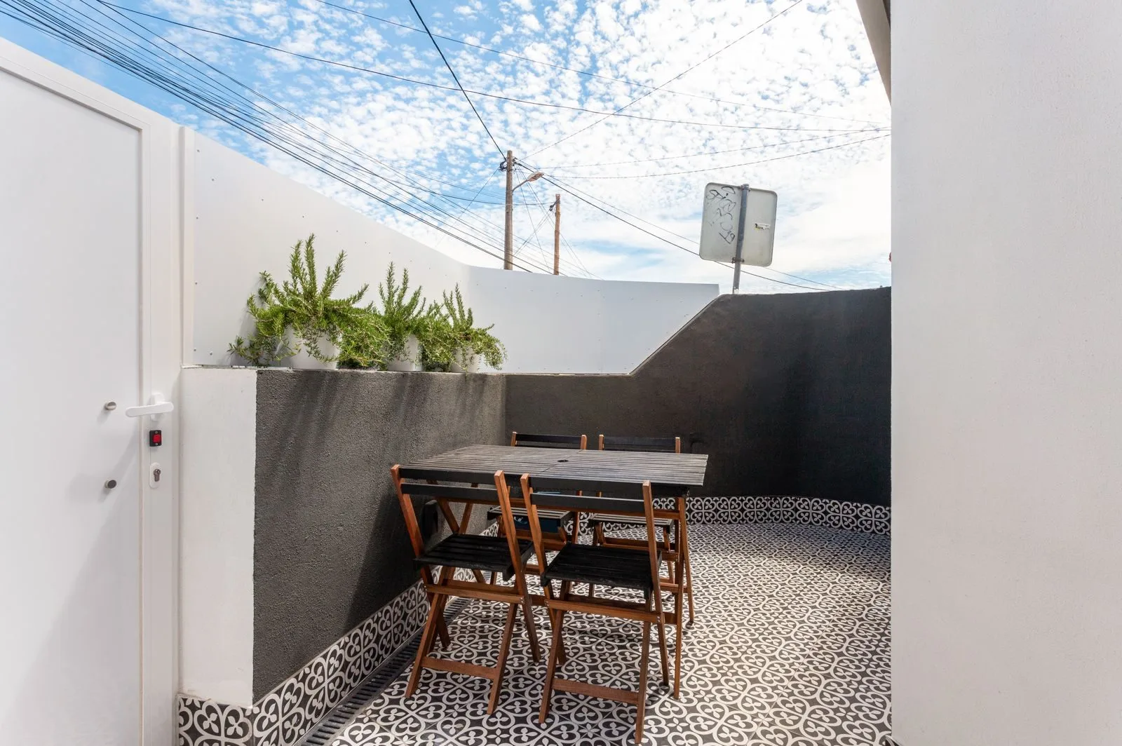 Private terrace with Portuguese geometric tiles — Amoreira loft conversion Cascais by Maya's Homes