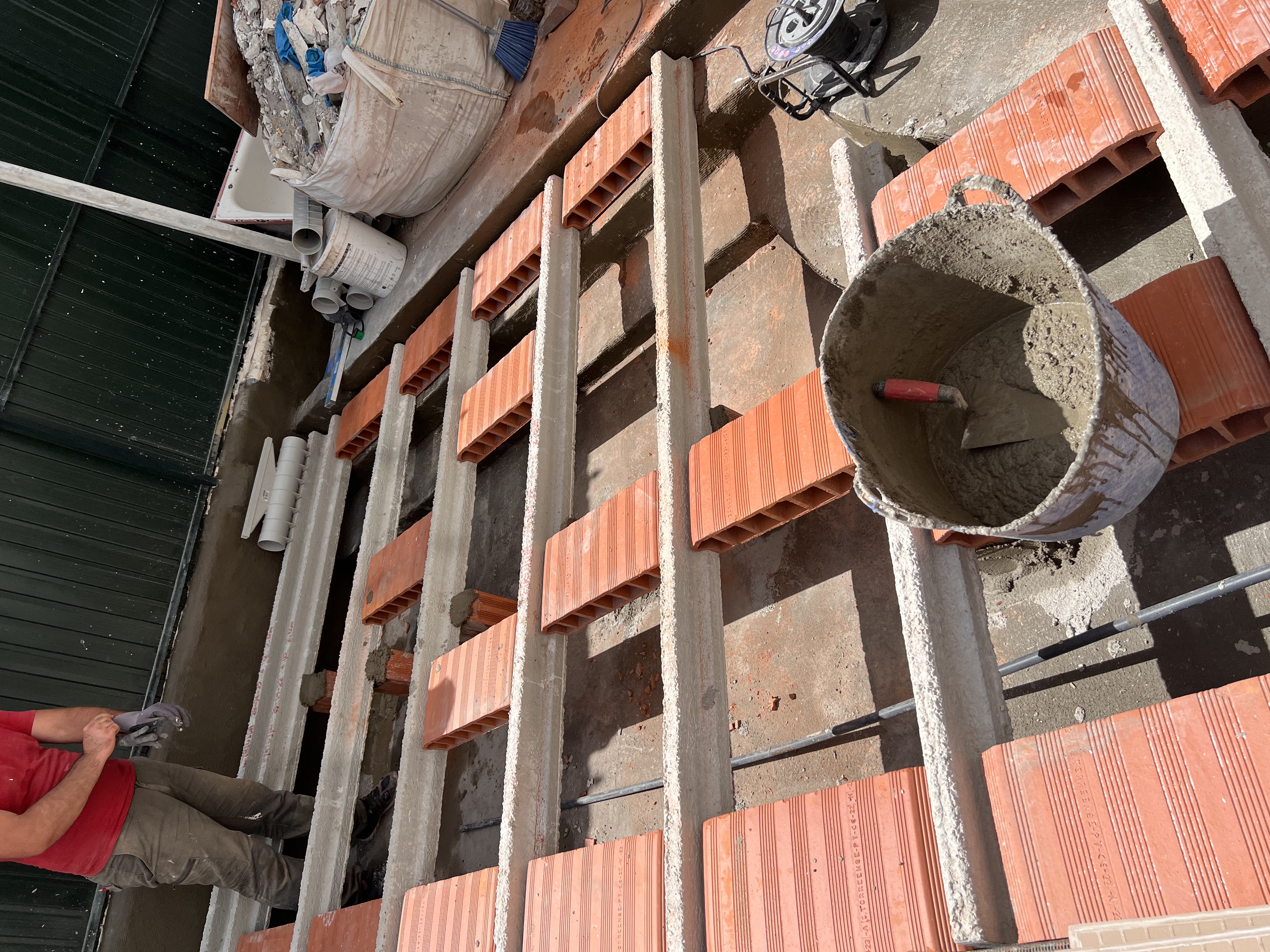 Rosa during &mdash; new structural substructure being built up over the waterproofed slab, raising the patio floor to the apartment level so there is no step down