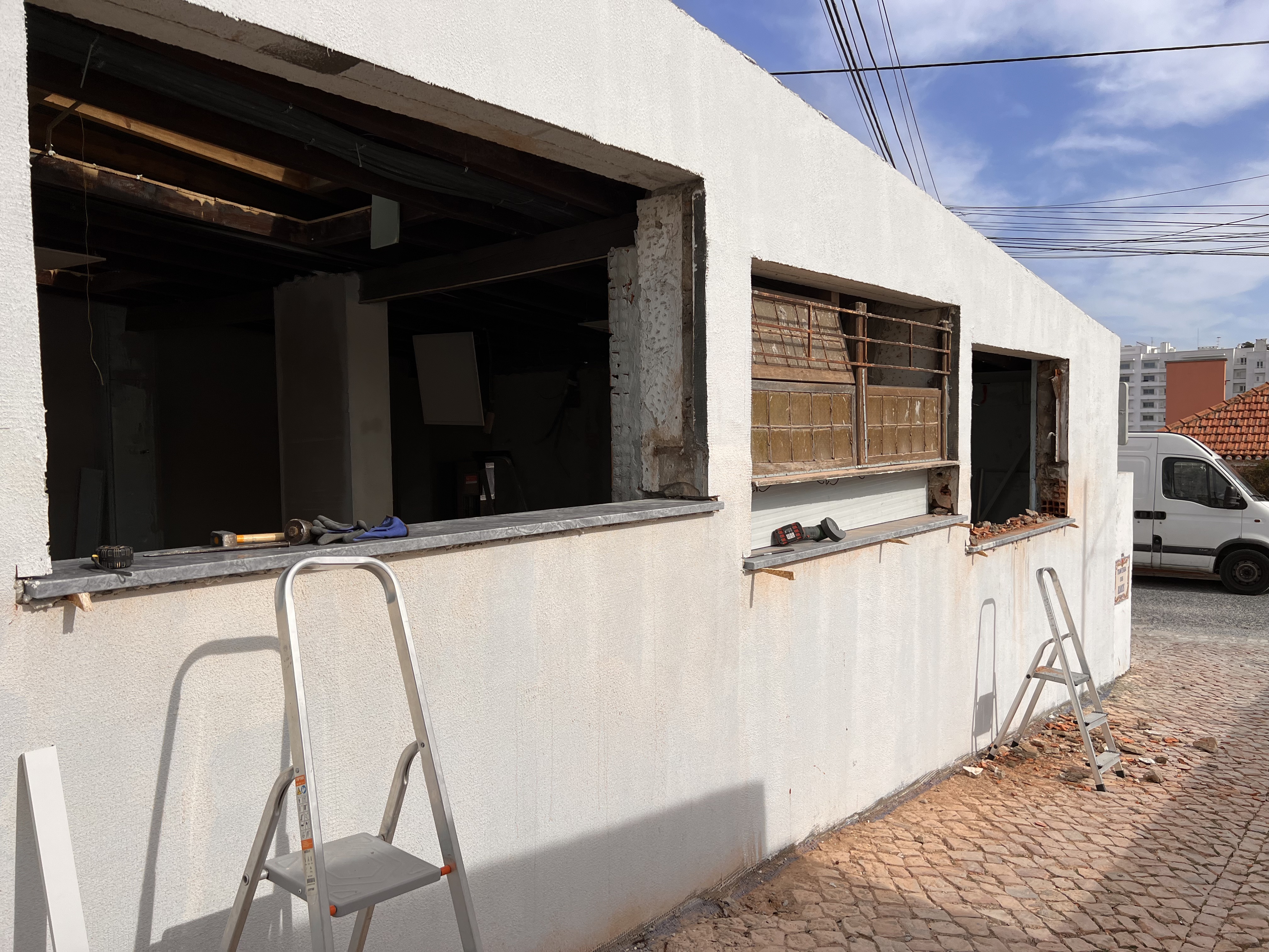 The Tasca during &mdash; window openings cut out of the side wall, step-ladders and tools waiting on the cobbled street outside
