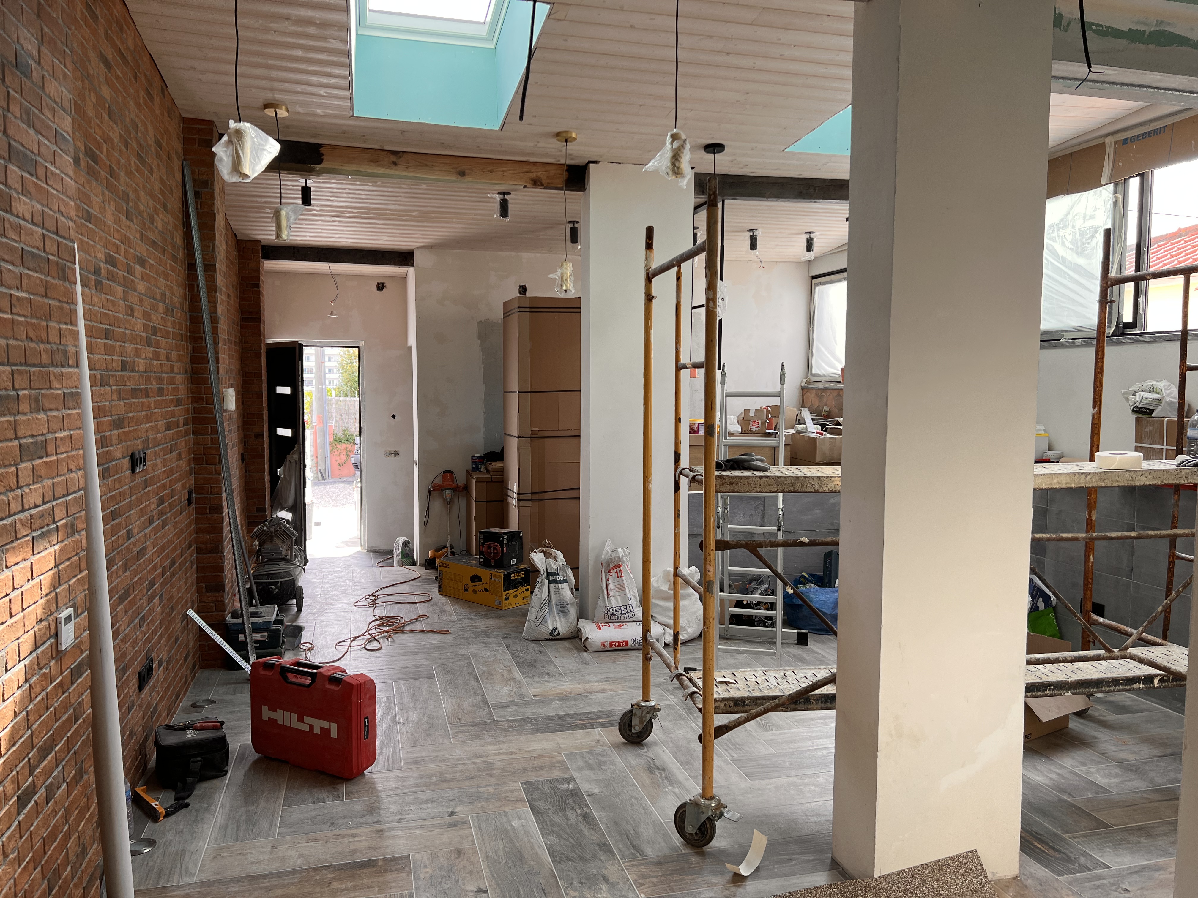 The Tasca during &mdash; herringbone oak floor laid, exposed brick wall preserved, original timber ceiling beams kept, scaffolding still in place for last fixes