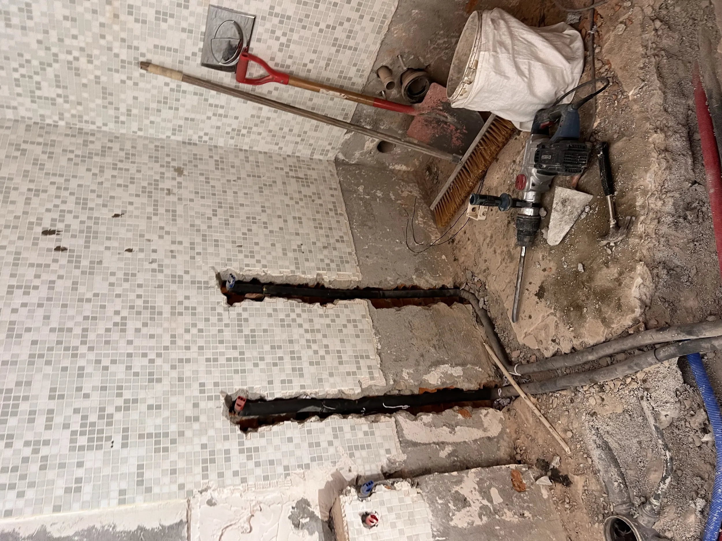 Belle Rivi&egrave;re mid-renovation &mdash; new sewage lines being cut into the bathroom floor through the original mosaic tile