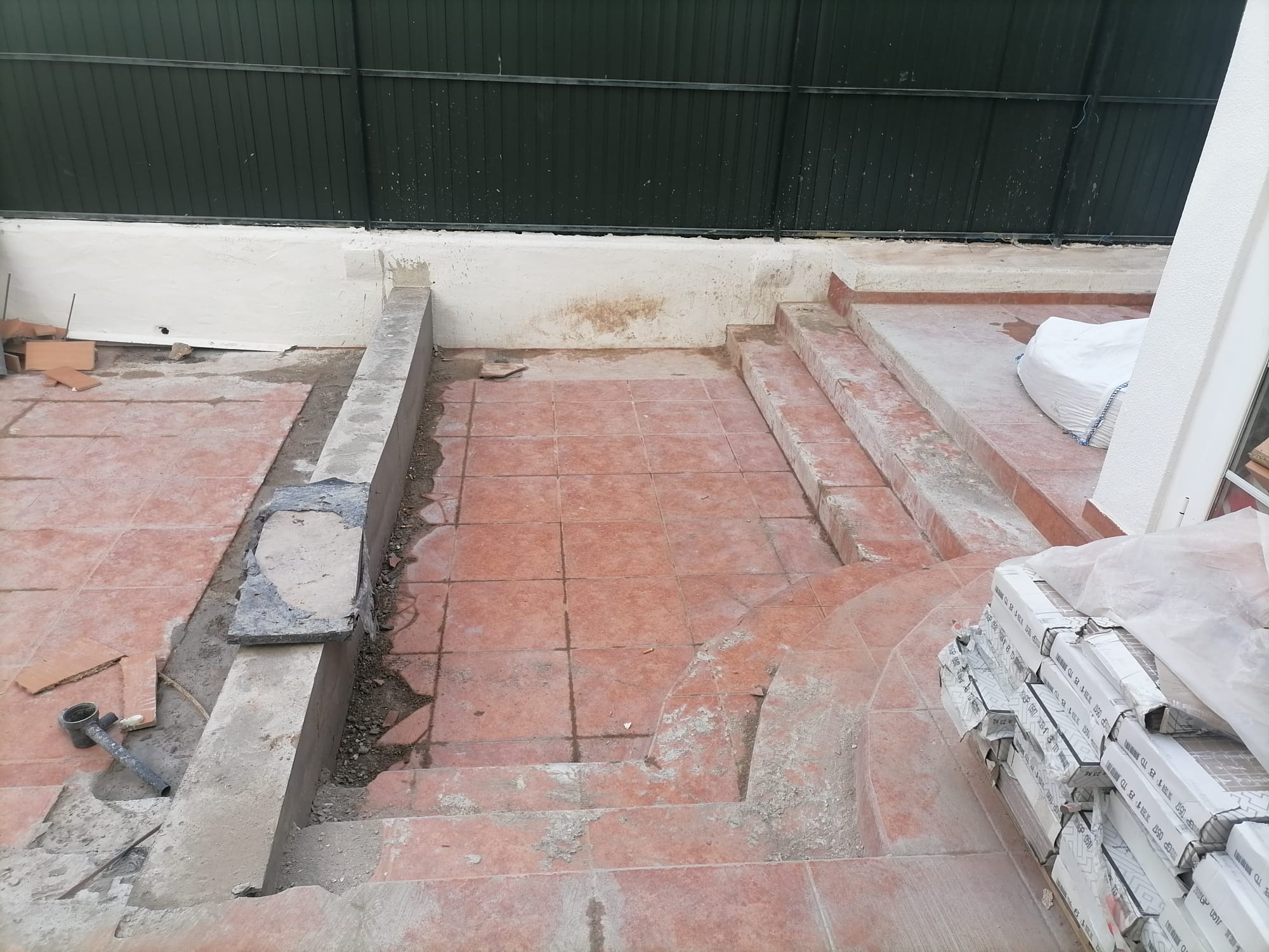 Rosa during &mdash; the original patio tile and trip-step coming up, new cement strips forming the level base for the extended footprint