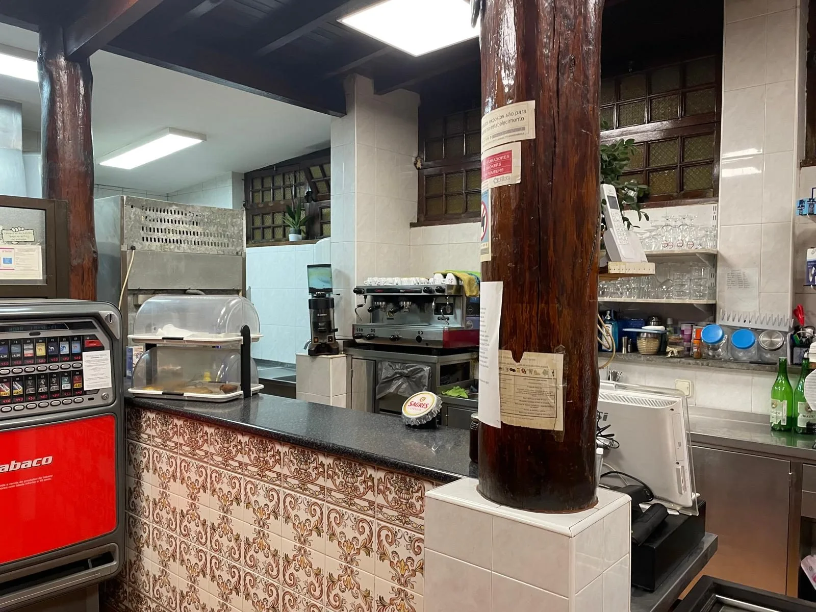 The Tasca before &mdash; the original cement bar counter, timber posts, decades of glasses across it