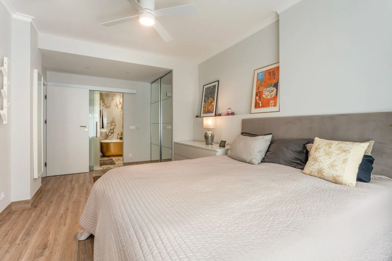 Master suite with gold freestanding bathtub — Parede renovation by Maya's Homes