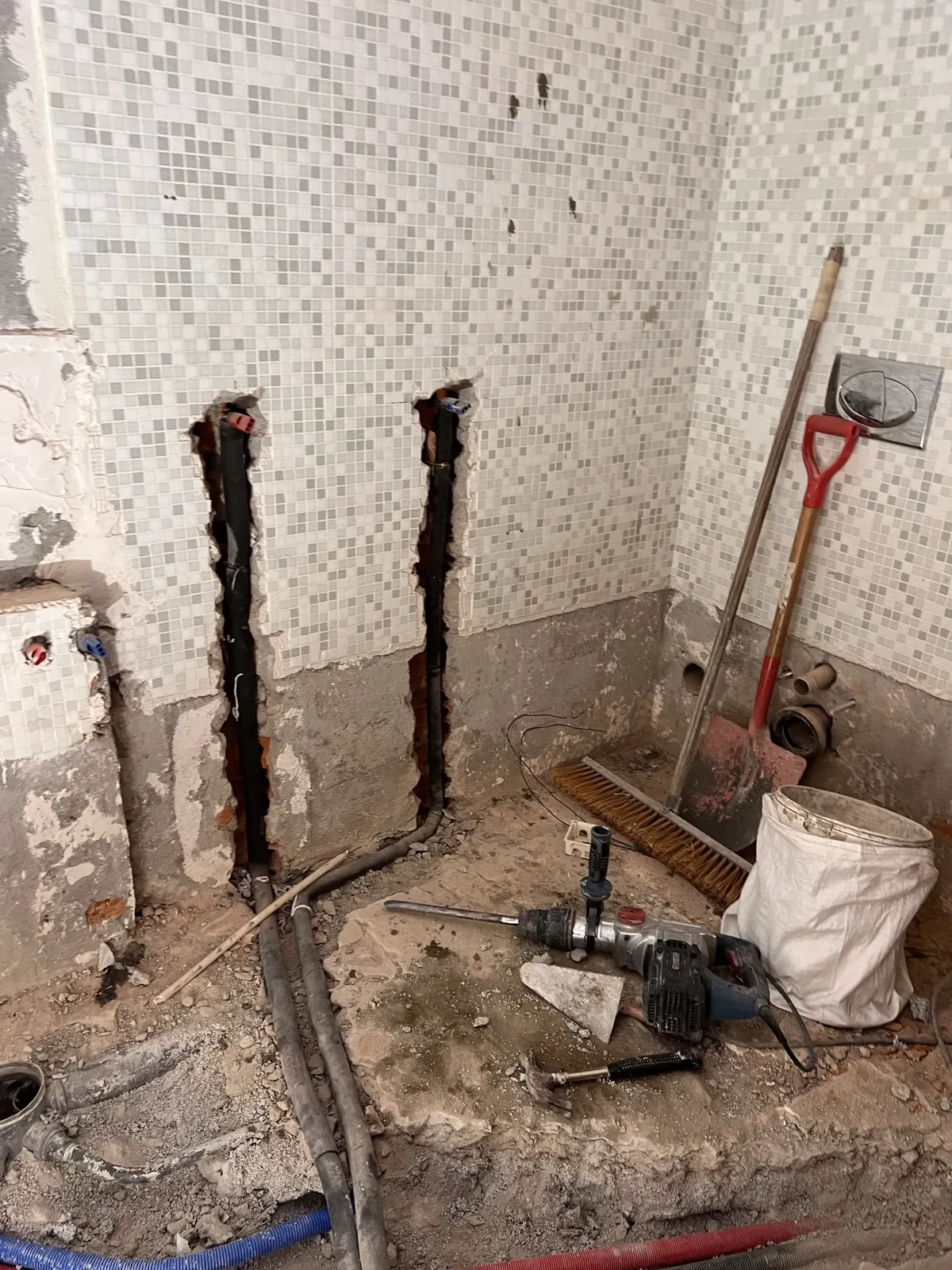 Belle Rivi&egrave;re mid-renovation &mdash; new sewage lines being cut into the bathroom floor through the original mosaic tile