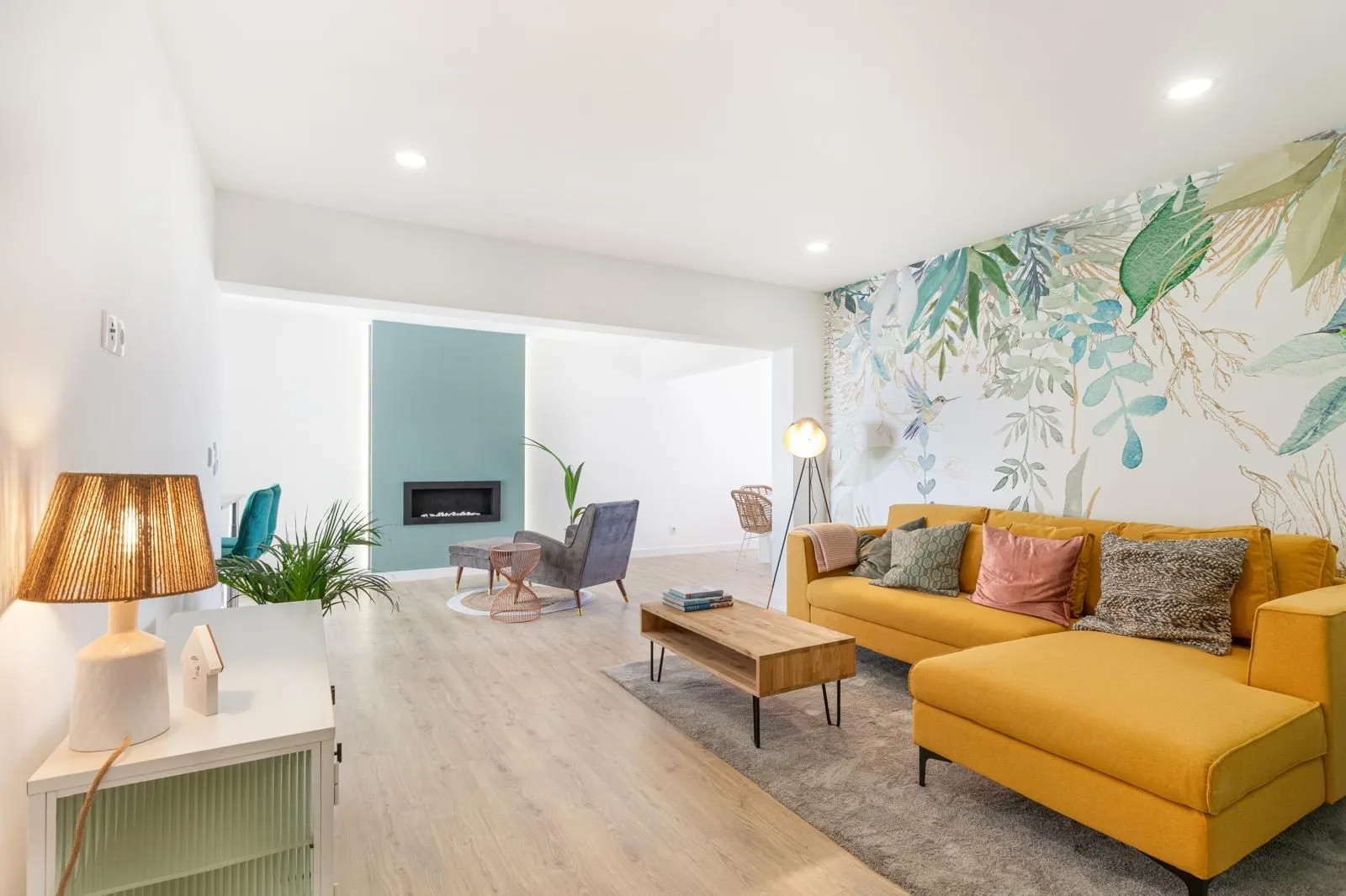 After — renovated open-plan living room with botanical wallpaper — Rebelva T2 by Maya's Homes Cascais
