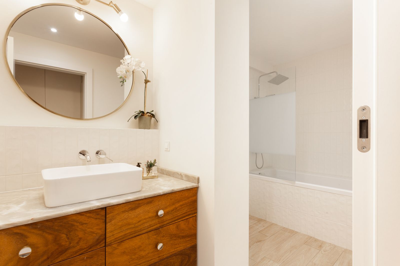 Second bathroom — oval mirror and walnut vanity