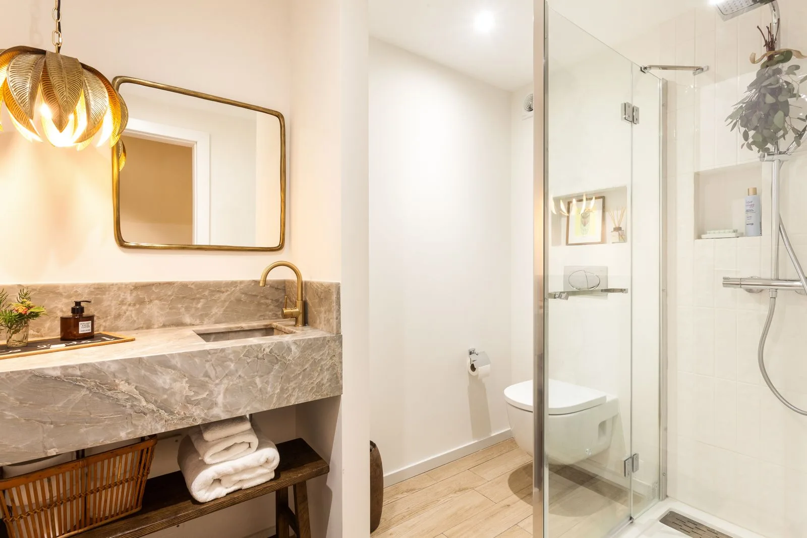 Powder room with sculptural brass basin — Riviera villa renovation Cascais by Maya's Homes