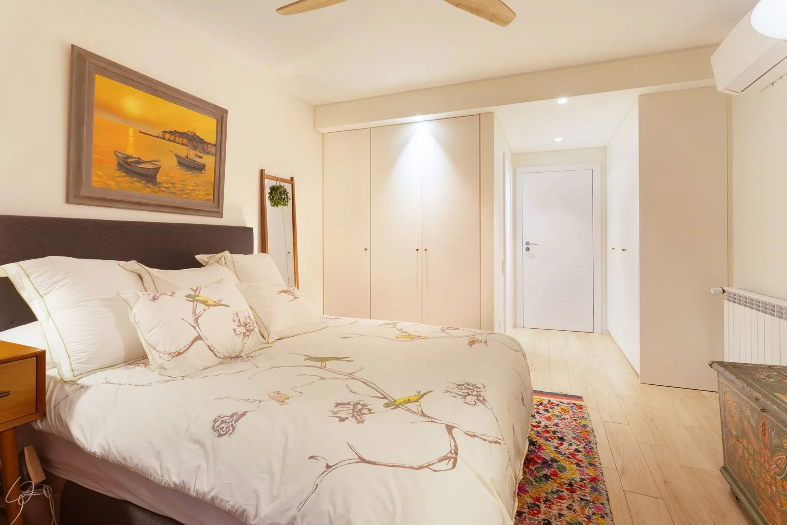 Master bedroom with built-in wardrobes and terrace access — Riviera villa renovation Cascais by Maya's Homes