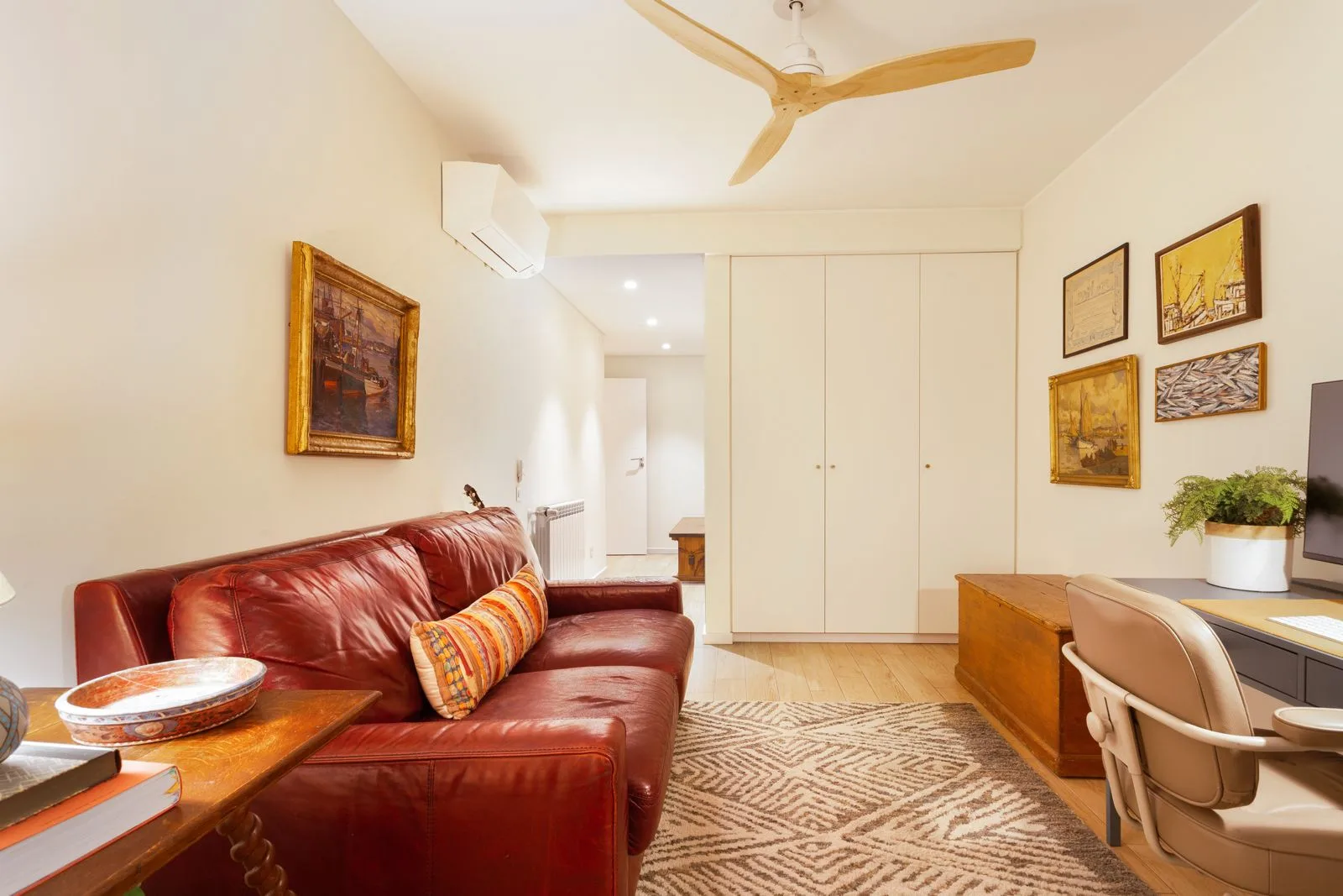 Home office with red leather sofa and built-in storage — Riviera villa Cascais by Maya's Homes