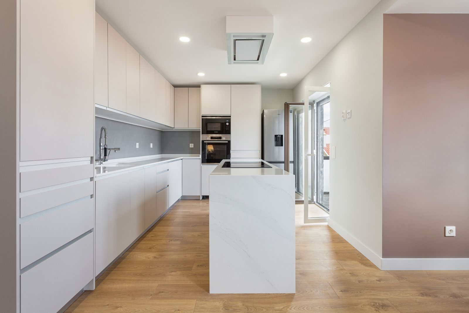 Kitchen with cream cabinets and quartz island