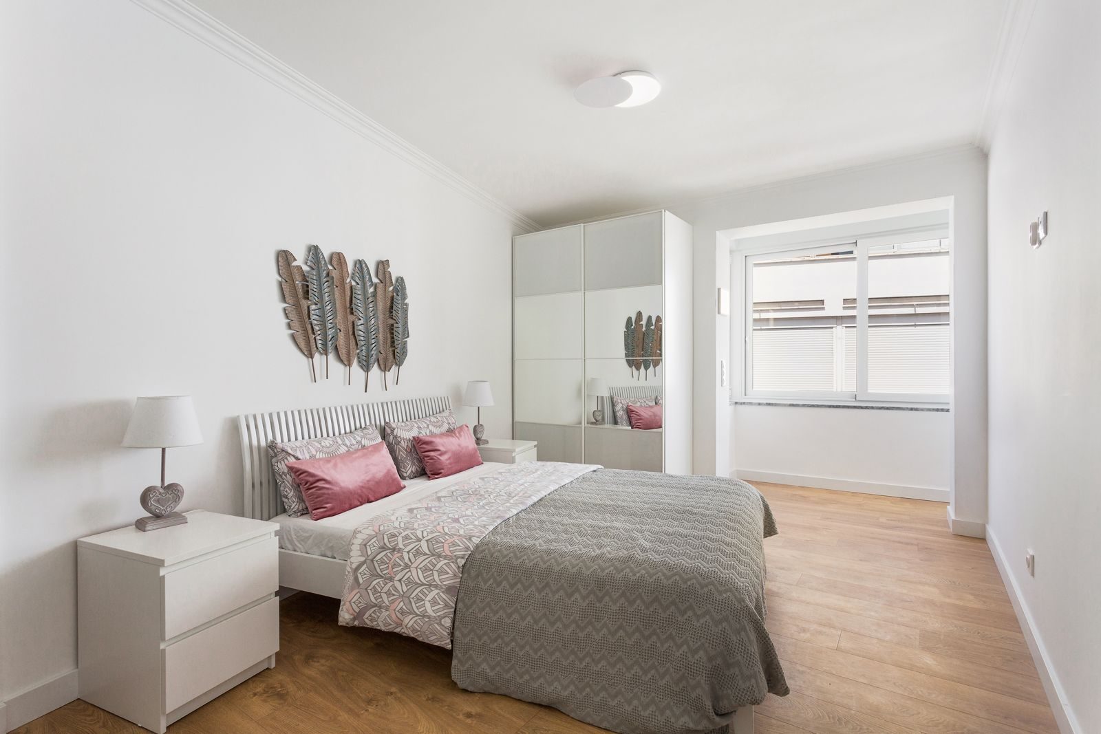 Master bedroom with feather wall art