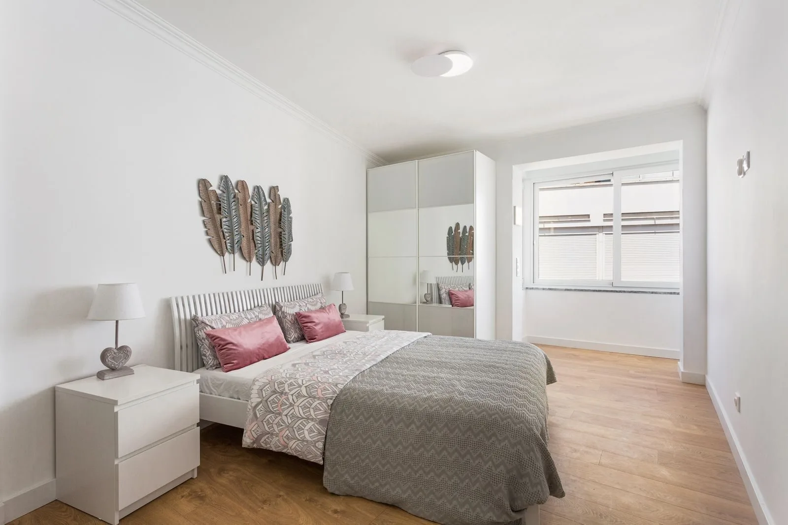 Master bedroom with feather wall art — Figueiras renovation by Maya's Homes