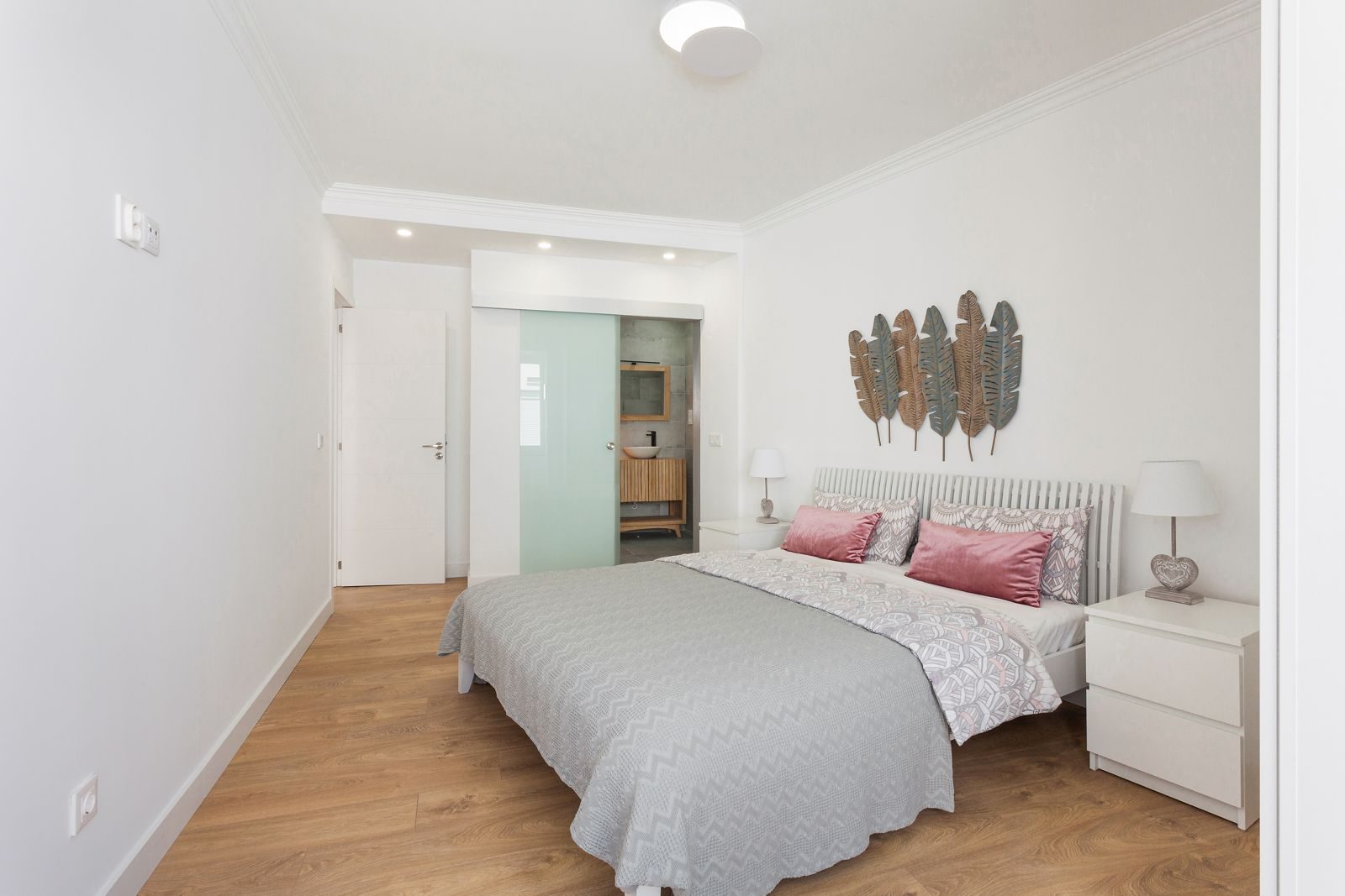 Master bedroom with en-suite visible through frosted glass
